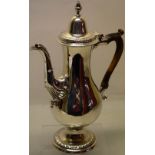 A George III North Country silver coffee pot, the pear shaped body with a cast scroll fluted swan