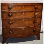 A small Regency mahogany veneered bowfront chest, the top edged with stringing above four long