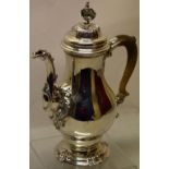 A fine George II rococo silver coffee pot, the inverted pear shape body with a cast chased leaf
