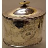 A Victorian silver oval biscuit box, with engraved beaded border, floral swags and a boars head
