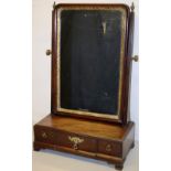 A mid eighteenth century mahogany toilet mirror, with a gilt gesso border and brass handles to the