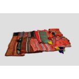 Six Moroccan sashes or turban wraps, one with long plaited woollen ties trimmed with metal discs;