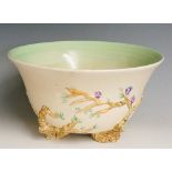 Clarice Cliff - a Newport pottery circular bowl the buff body relief moulded with prunus branches,