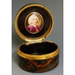 A 19th Century green papier maché circular box the hinged lid decorated with musical trophy and