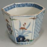 An hexagonal porcelain tea bowl the panelled exterior decorated in under glaze blue and enamelled