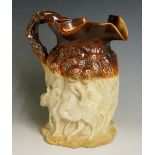 A good Victorian salt glazed Bachanalan moulded jug the upper part of brown colour with crabstock