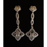 A good pair of diamond pendant earrings the flower shaped terminals pave set with four diamond