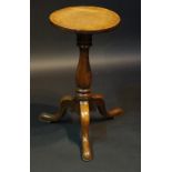 A good mid 18th Century oak candle stand the circular top above a bold vasular turned column,