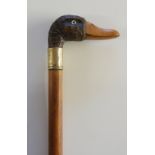 A walking stick with the handle realistically carved as a duck's head, plain brass collar marked WM,