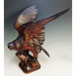 Black Forest - a fine carved eagle resting on a stump, decorated beak, glass eyes, 47cm high,