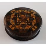 A circular Tunbridge ware box of shallow form, parquetry inlaid top, 6cm diameter,