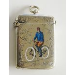 A Victorian enamelled vesta case detailed with a gentleman riding a bicycle within a foliate frame,