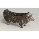 A metal pig, possibly previously a pin cushion or pen nib wipe,