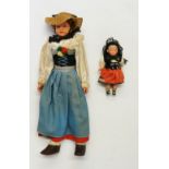 Two celluloid dolls, one 25cm high, the other 9cm high,