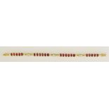 An 18ct yellow gold bracelet set 22 oval rubies alternately spaced with diamond set bales,