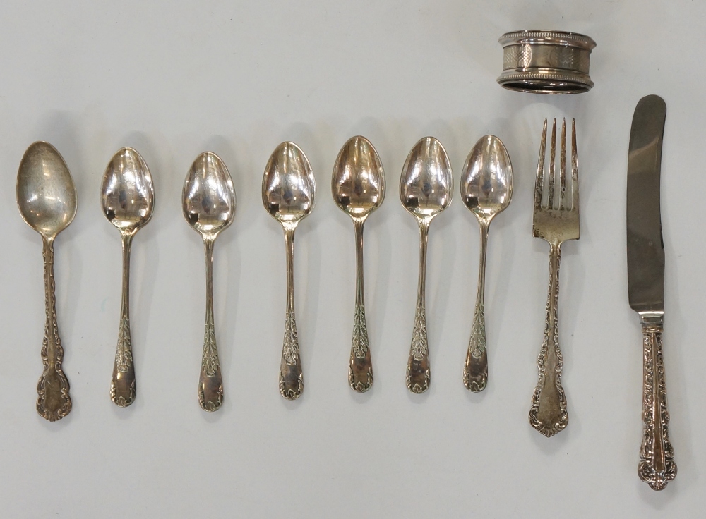 A selection of items to include: a set of six silver? teaspoons with foliate cast designs to stems,