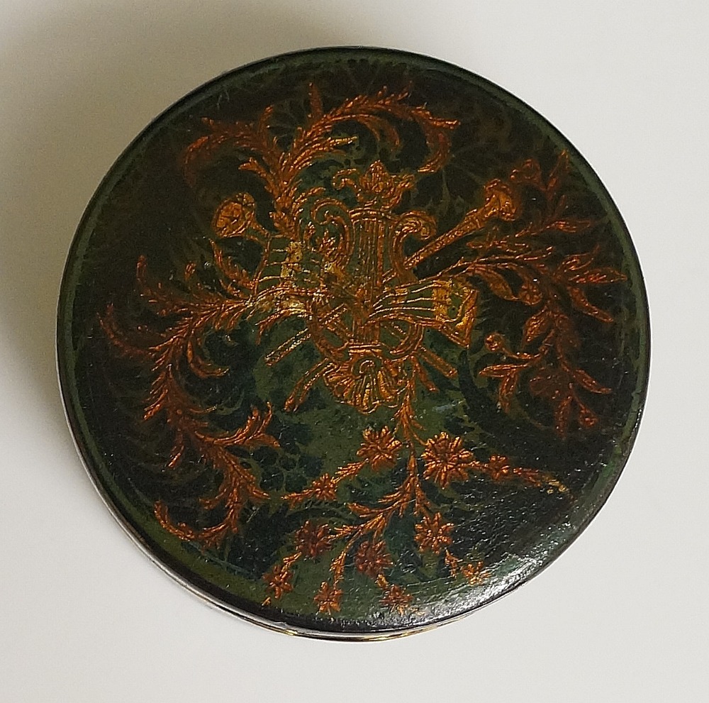 A 19th Century green papier maché circular box the hinged lid decorated with musical trophy and - Image 2 of 2