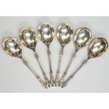 A set of six large apostle spoons, all with matching terminals, the apostle holding a book,