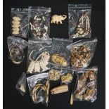 A bag of mostly ivory and bone jewellery to include: a carved bone necklace with tribal style masks;
