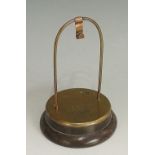A brass pocket watch stand of simple arched form the circular base stamped HMS Temeraire, 1918,