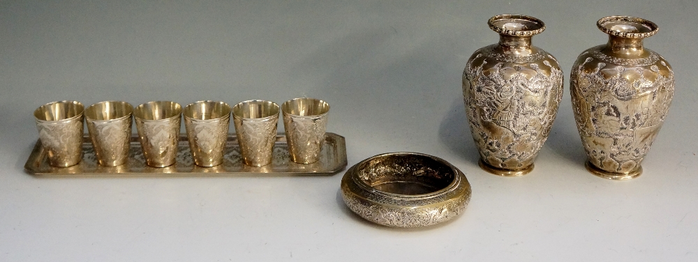 A selection of Indian ? silver coloured metal items to include: a pair of small vases,