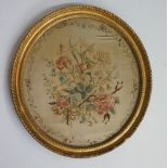 A George III oval needlework picture the panel worked in coloured silks and wool with floral sprays