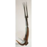 An unusual mammoth stag's antler handled carving fork, 77cm long,