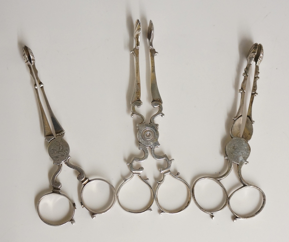 A collection of three George II and George III sets of sugar tongs,