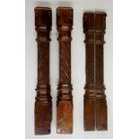 A pair of 19th Century walnut newel posts with rounded square tops above octagonal collars,