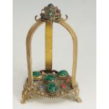 An embossed gilt metal triple watch stand set coloured glass cabochons,