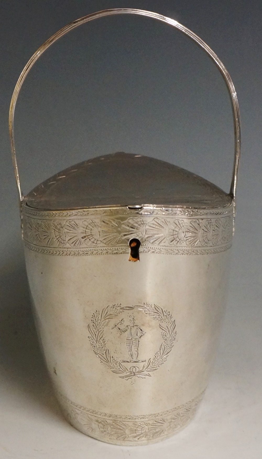 A George III navette shaped silver lidded basket with reeded handle,