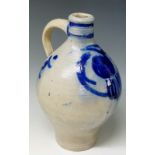 An 18th Century salt glazed Bellarmine flask decorated with flowerhead beneath moulded rims the