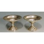 A pair of small silver dishes, the plain bowls with folded over rims,