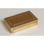 A 19th Century French gold box the hinged lid with finely engine turned rectangular centre within