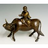 A Chinese bronze censer modelled as a figure seated on an ox,