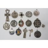 A selection of mostly pewter pendants, to include two Scottish hardstone type designs,