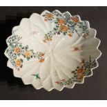 A Japanese porcelain petal shaped dish with serrated rim decorated in kakiemon style with bird,