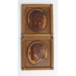 A pair of 19th Century carved wooden oval portrait plaques,