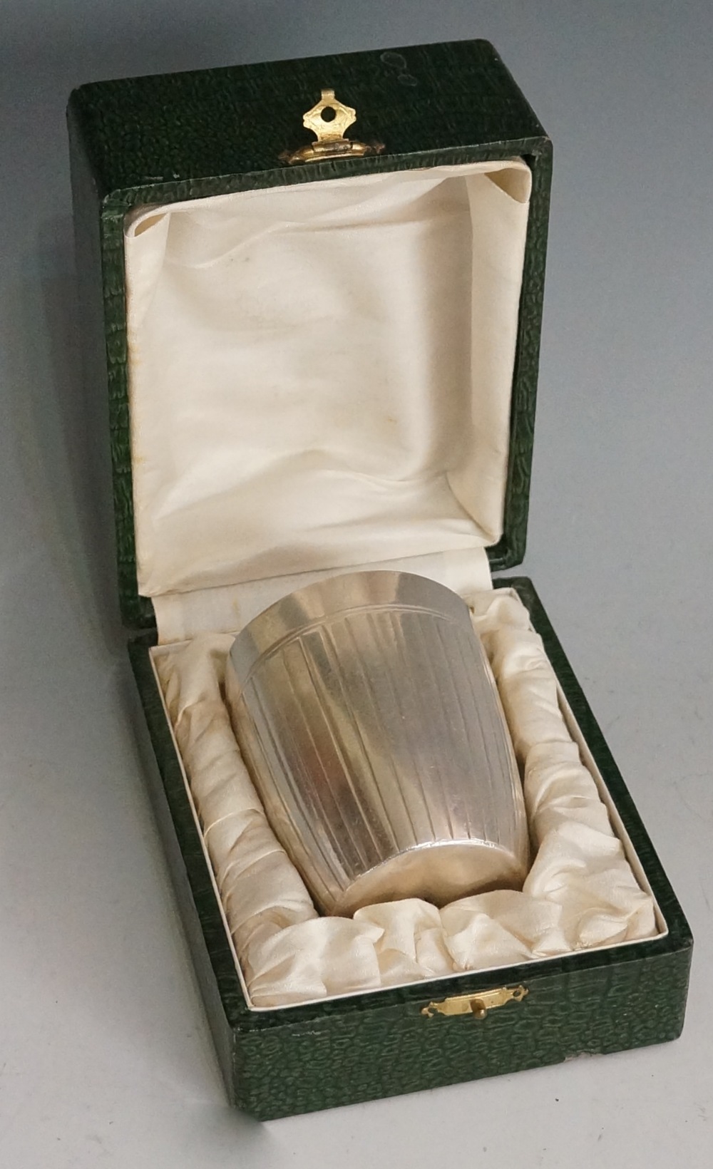 A white metal Christofle beaker, the plain rim engraved to one side 'P.