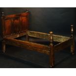 A rare mid 17th Century oak bedstead, the headboard triple panelled with pair of turned finials,