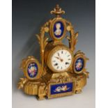 A French ormolu and porcelain mantel clock the drum shaped case surmounted by an oval porcelain