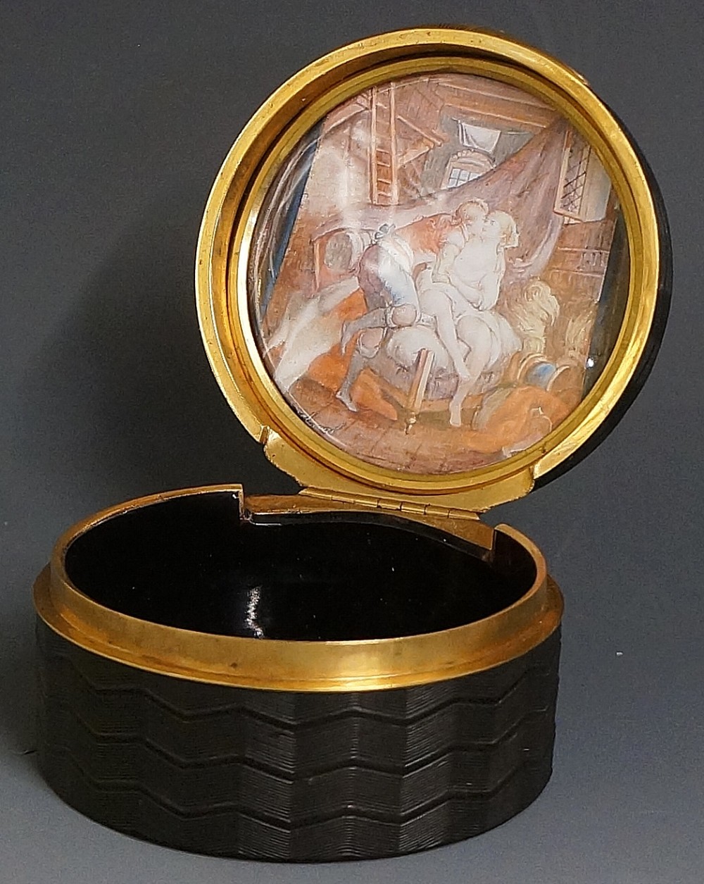 A fine early 19th Century engine turned tortoiseshell circular box the hinged lid with gilt metal