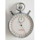 An Omega split second stopwatch with black and red numerals inscribed Omega, chromium plated case,