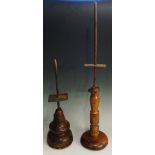 Two turned wooden and wrought iron hawk rests, each with vertical iron posts,