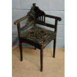 An ebonised corner chair, the seat and a