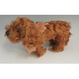 An Allwin toy dog, plush brown hair, gla