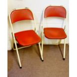 A pair of vintage metal folding chairs,