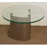 A glass top coffee table of contemporary