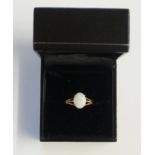 A 9ct gold white opal ring, size