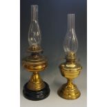 A Victorian brass oil lamp with black po